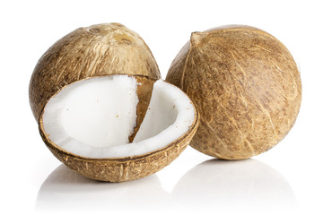 Group of two whole one half of fresh bio coconut one piece is cut out isolated on white background