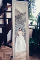 Fototapeta premium beautiful bride brunette looks in the mirror 