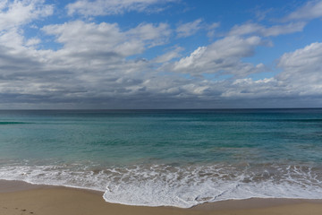 waves in the ocean and blue sky