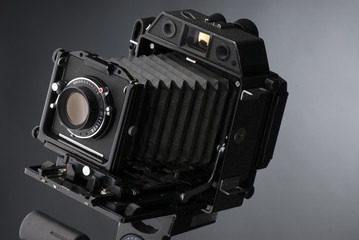 An old professional camera on gray background