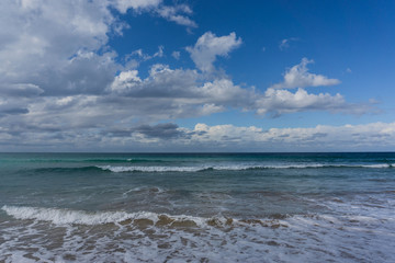 waves in the ocean and blue sky