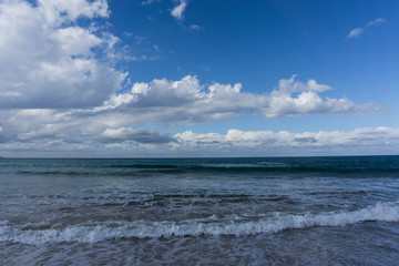 waves in the ocean and blue sky