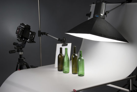 Modern photo studio with professional equipment, bottles