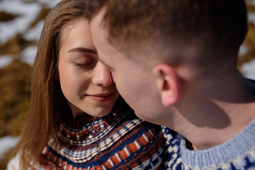Fototapeta premium Young couple relaxing on the snow