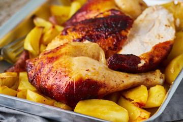 Grilled chicken meat, leg, thigh with baked potatoes. Side view, close up