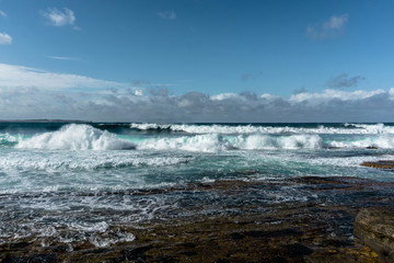 waves in the ocean and blue sky