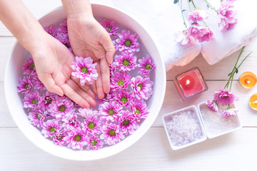 Obraz na płótnie Canvas Spa treatment and product for female feet and manicure nails spa with pink flower for relax and healthy care. Therapy and Aroma for body women. Healthy Concept