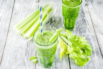 Healthy vegan food and drink. Diet green cucumber and celery smoothie cocktail, on a wooden background,