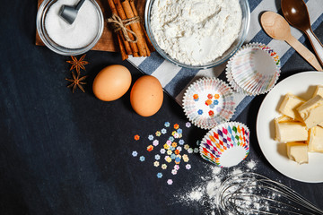 Bakeware baking, fresh ingredients and cookies on a black background. Flat lay bakery text image space