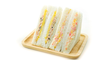 Two pieces of sandwich in wooden plate 