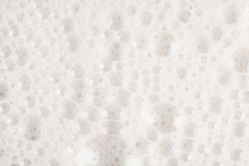 Soap foam and bubbles on white background