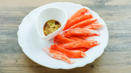 crab sticks with wasabi and soy sauce in white dish 