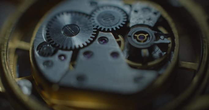 Old clock mechanical part working mooving white lightning from right side static angle view ProRes 4444