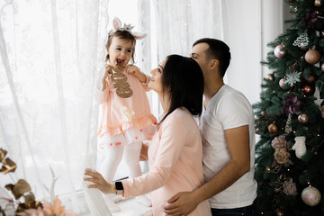Little girl is having fun, and her parents are laughing