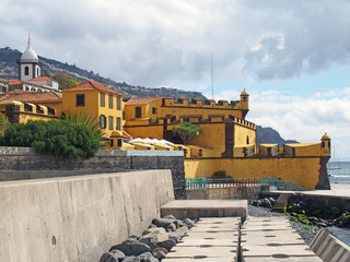 view of the 17th century yellow fort Fort of São Tiago in funchal madeira taken from the seafront...