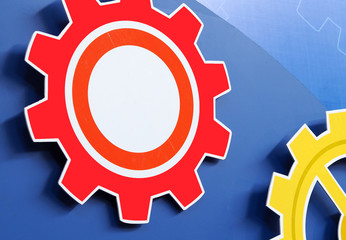 Large cog wheels engine gear wheels blue background, industrial background