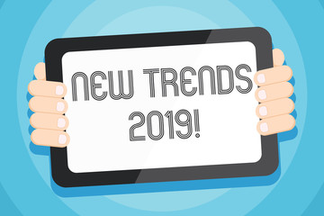 Text sign showing New Trends 2019. Business photo showcasing general direction in which something is developing Color Tablet Smartphone with Blank Screen Handheld from the Back of Gadget