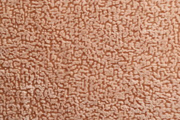 The surface of the factory fabric flock with a chaotic pattern. Upholstery for furniture, pleasant to the touch. Color beige and pink. The fabric is fleecy, durable and reliable.