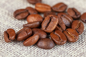 Natural roasted coffee beans on rural sackcloth