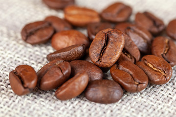 Natural roasted coffee beans on rural sackcloth