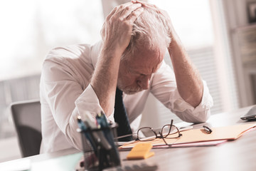 Stressed businessman sitting in office