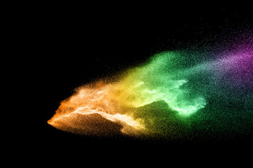 Fototapeta premium Abstract colorful powder explosion on black background.Freeze motion of dust splash.Painted Holi.