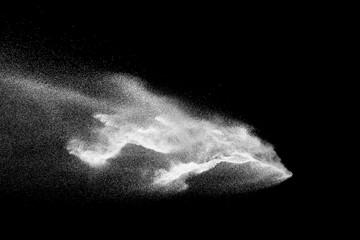 Fototapeta na wymiar Freeze motion of white dust particles on black background.
