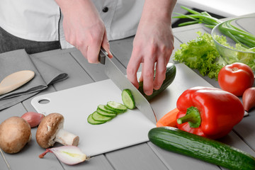 Man cutting a cucumber