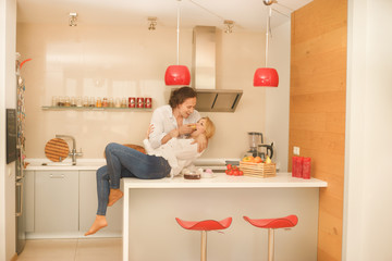 couple playing in kitchen