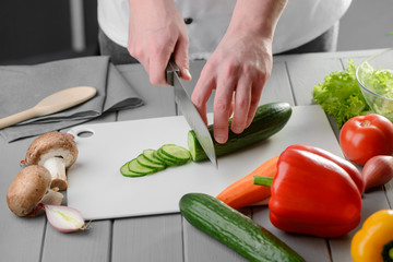 Chef cutting a cucumber