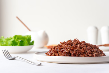 Cooked red rice on the table. Vegetarian food. Healthy food.