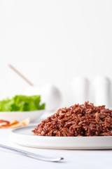 Cooked red rice on the table. Vegetarian food. Healthy food.