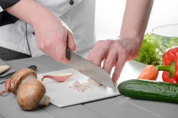 Chef chopping an onion