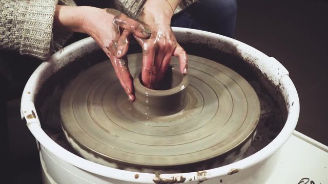 Woman forming a clay pot. DIY