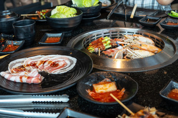 Decorate food, Japanese Food , Breakfast ,Barbecue meat on grilling mesh of charcoal fire. Korean traditional food grilling style barbecue  in buffet restaurant