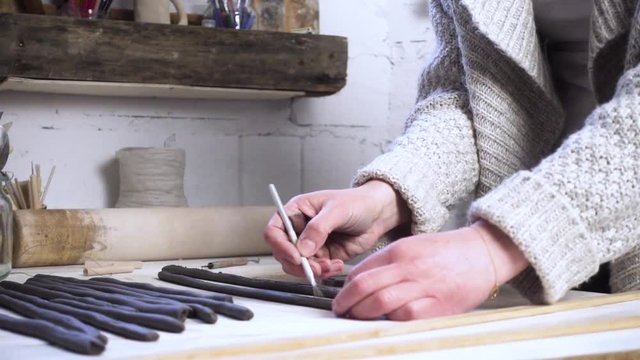 Woman making clay pottery. Creative occupation