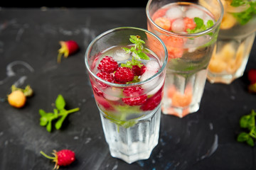 Fototapeta na wymiar Detox infused flavored water with three color raspberry