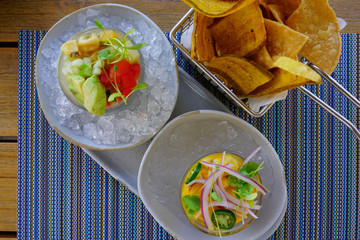 Dish of raw fish ceviche with onions on ice