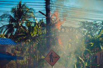 power pylon overload or electric short circuit at transformer on poles and fire or flame with smoke...