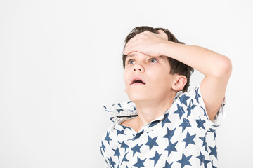 Portrait of an emotional boy on a white background.