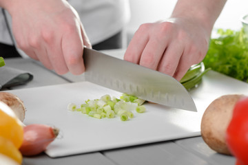 Chef chopping spring onions