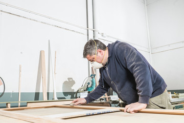 Male carpenter working in his carpentry workshop.