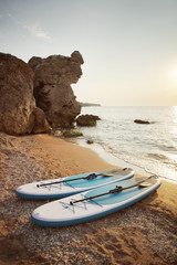 SUP board on a sunset beach.