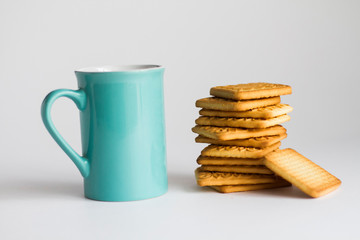 Fototapeta na wymiar Blue tea and coffee cup with cookies on white background