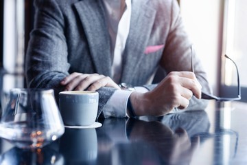 Take a break and have coffee. Business man drinking coffee in a cafe.
