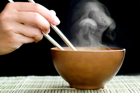Decorate food, Japanese Food , Breakfast , Lunch and dining by hot soup in wood bowl on mat which have a smoke on bowl black background.