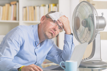 Man suffers from heat in the office or at home