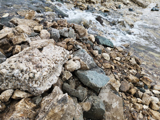 Fresh water stream in mountain brook, closeup. The texture of the rocky surface in the water