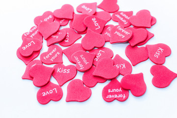 Heap of scattered red hearts background white love symbol