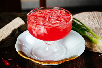 Fresh red goose sausage in a clear glass